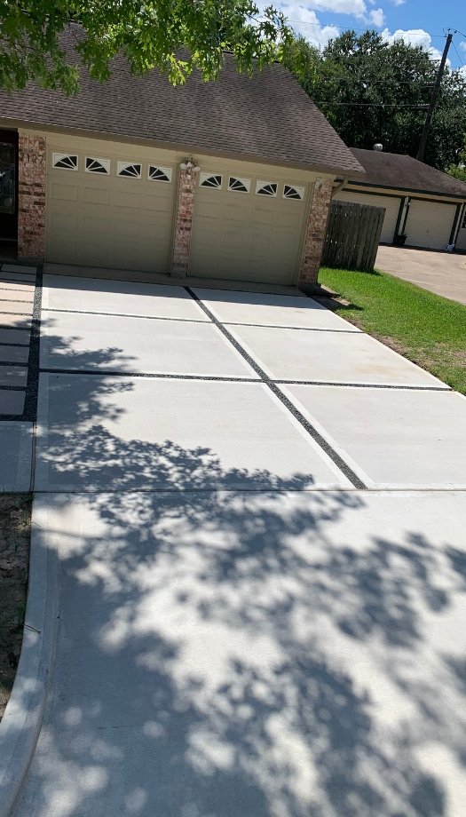 average home with concrete driveway paved